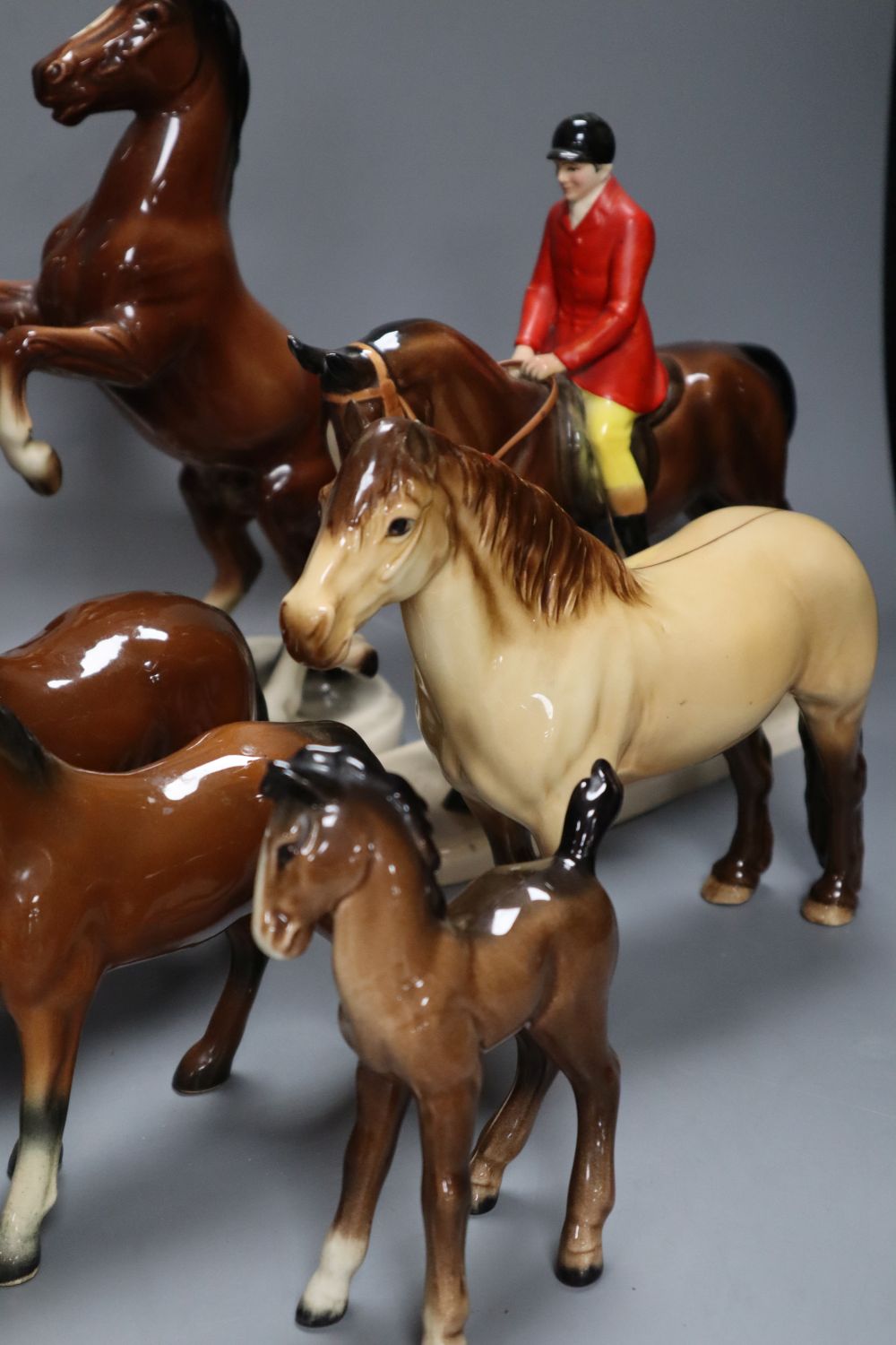 A collection of four various Beswick model horses including Highland, Another Bunch and Another Star, and three Continental horse model